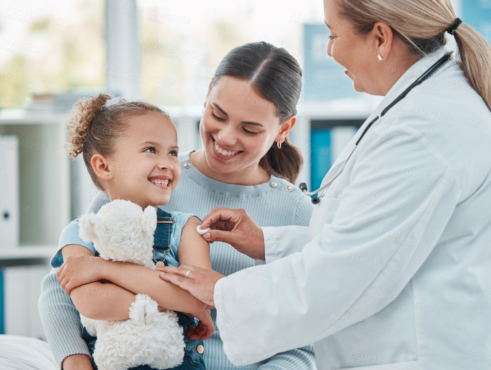Buy stock photo Pediatrician, girl and doctor with vaccine injection, cotton ball and flu shot on arm for disease or covid prevention in hospital. Woman, nurse and immunity of child against virus, bacteria or happy