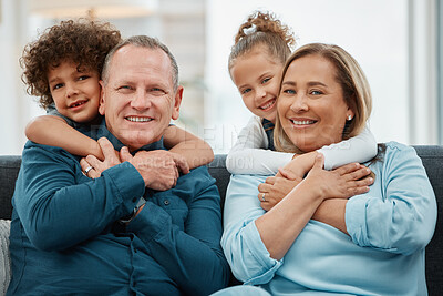Buy stock photo Shot of grandparents being hugged by their grandchildren