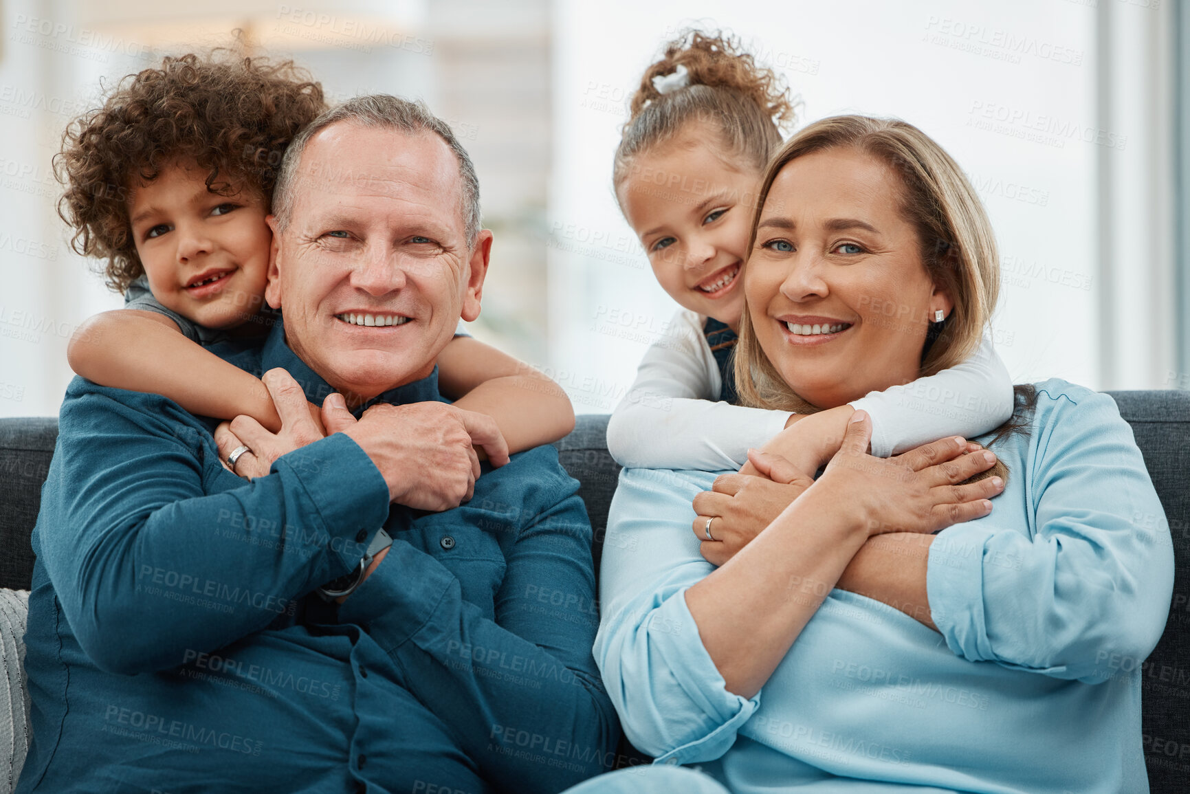 Buy stock photo Shot of grandparents being hugged by their grandchildren