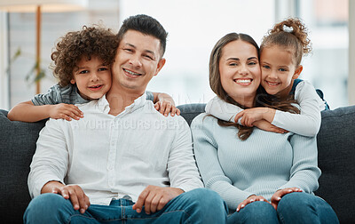 Buy stock photo Shot of a young couple being hugged by their children