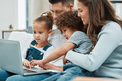 Buy stock photo Shot of a young family spending time together while watching a film on their laptop