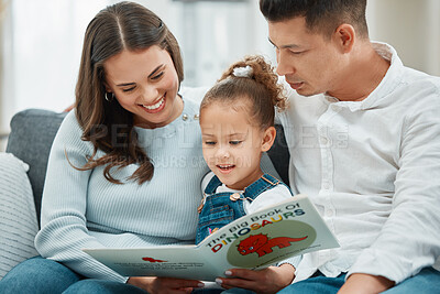 Buy stock photo Shot of a mother and father reading to their daughter
