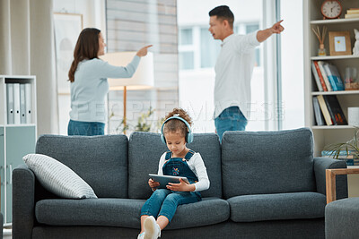 Buy stock photo Shot of a little girl being distracted by music while her parents argue