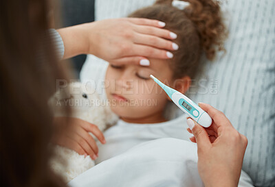 Buy stock photo Shot of a mother taking her daughters temperature