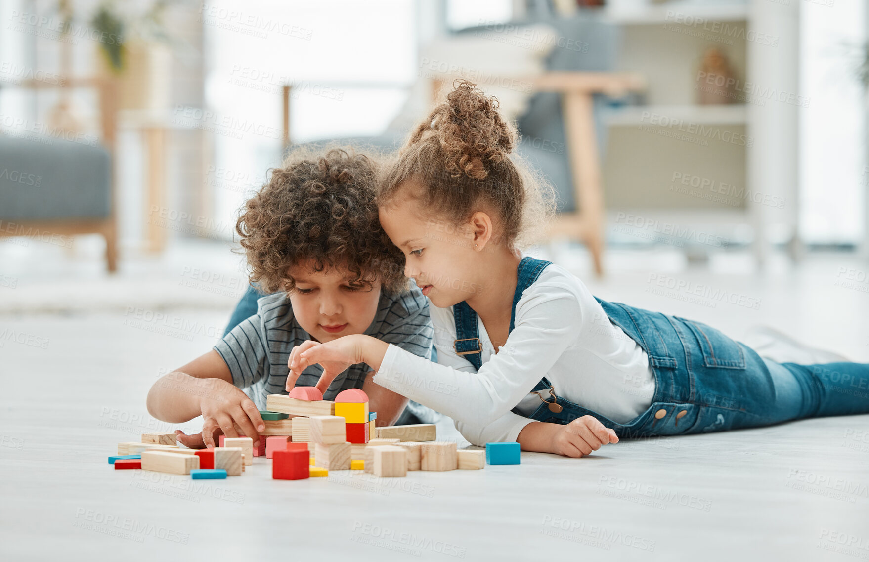 Buy stock photo Shot of two siblings playing with building blocks