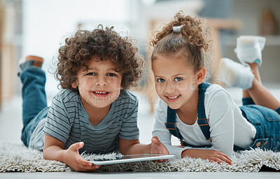 Buy stock photo Shot of two siblings playing together with their digital tablet