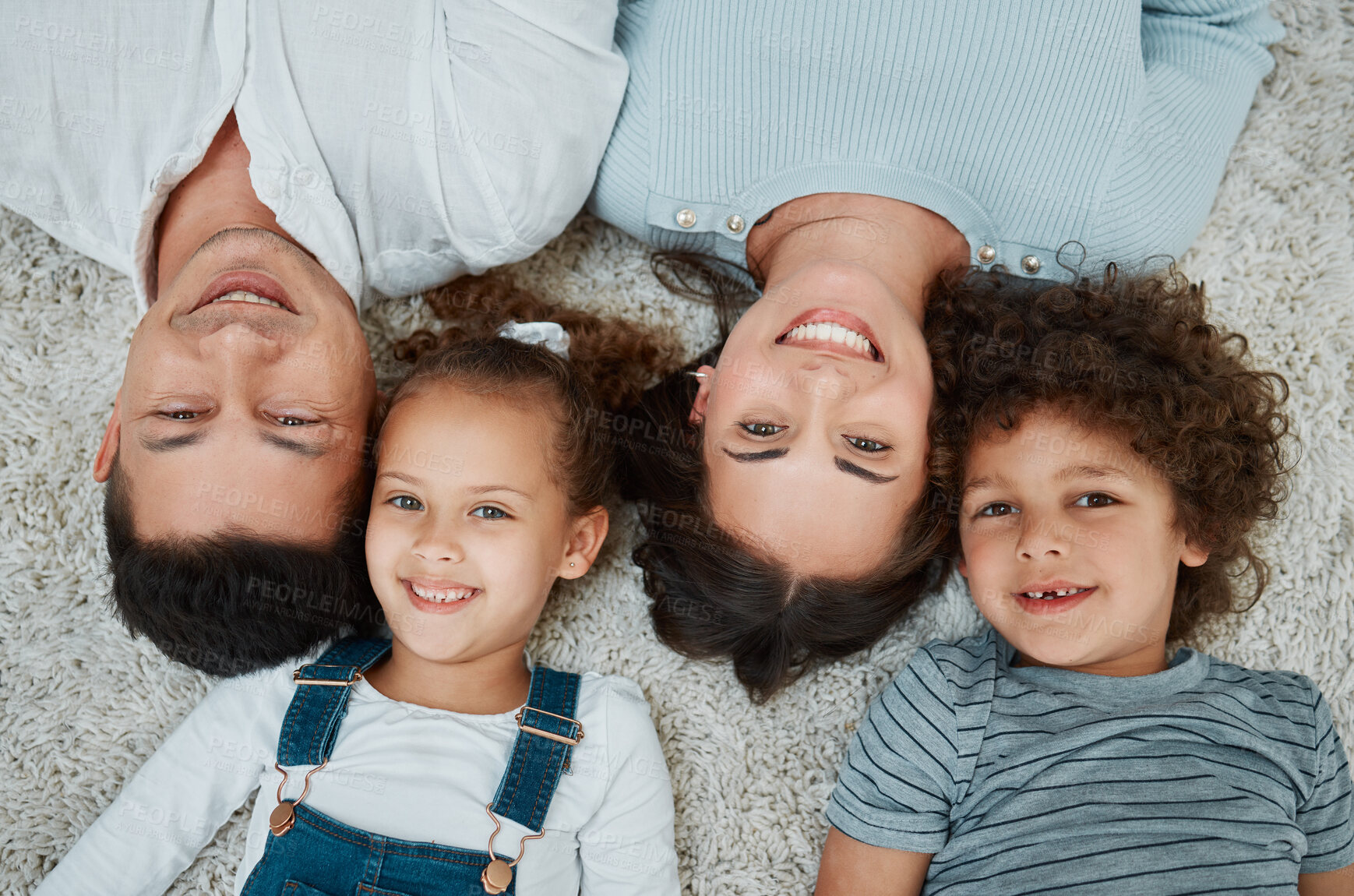 Buy stock photo Above, parents and children in portrait on carpet, relax and bonding together with connection as family. Home, father and mother with happy kids for development, childhood or security in house by top