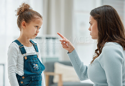 Buy stock photo Shot of a young mother scolding her daughter