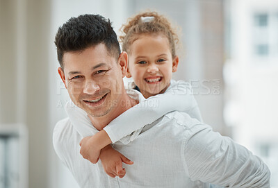 Buy stock photo Shot of a young father giving his daughter a piggyback ride