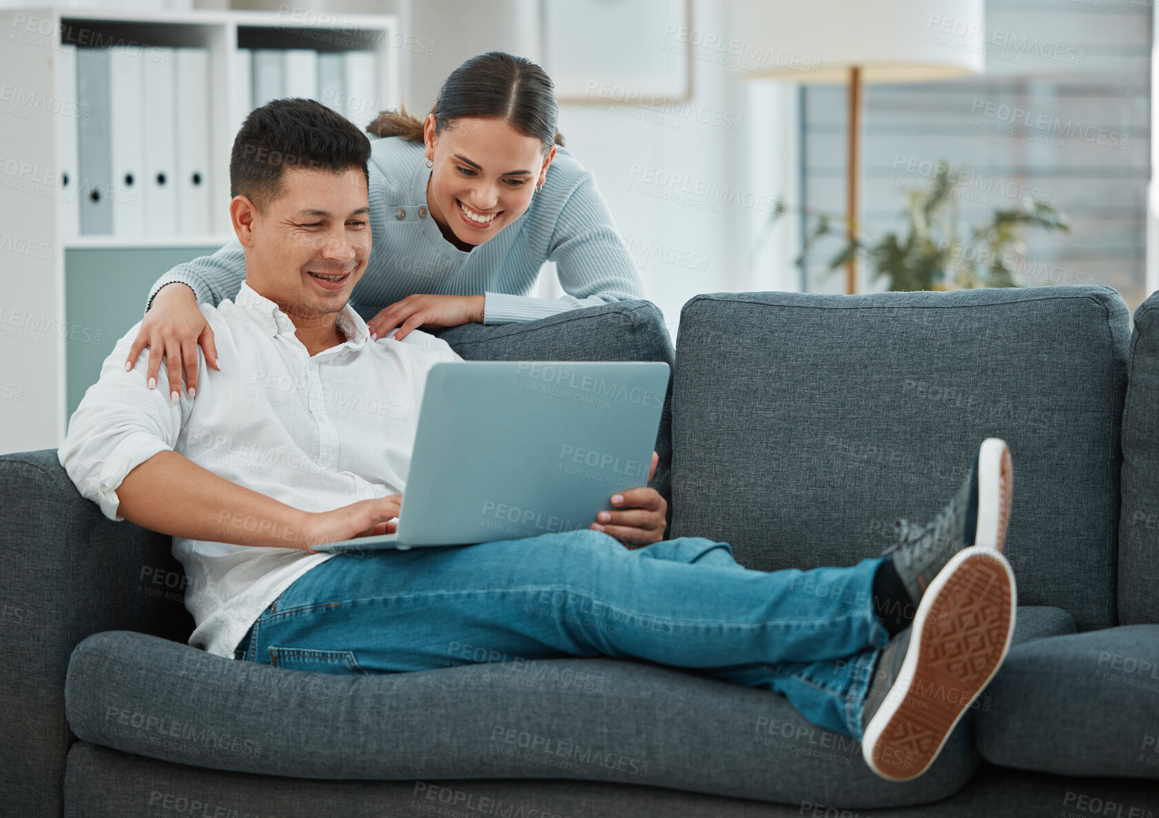 Buy stock photo Smile, laptop and couple with living room, sofa and relax in house or apartment for date. Happy, love and man with woman with funny video, meme or internet for video streaming or movie at home