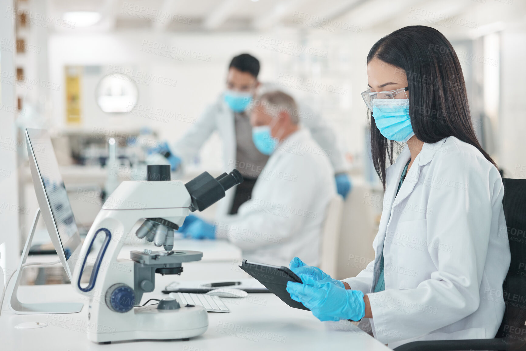 Buy stock photo Scientist, tablet and woman with microscope in lab for medical database, research and experiment info. Science, pharmaceutical and biotech with face mask for Mpox vaccine, pathogen and epidemiology