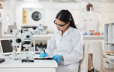 Buy stock photo Science, writing and microscope research for vaccine study and lab with virus analysis with notes. Woman, scientist and ppe for protection with medical journal and experiment with biotechnology