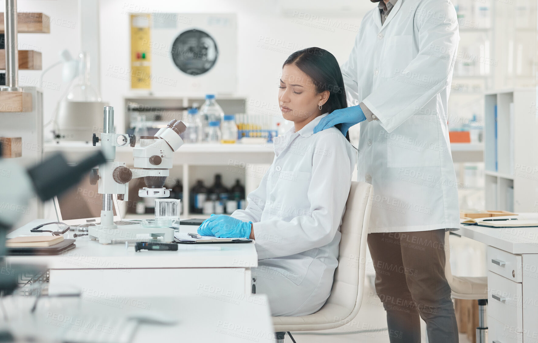 Buy stock photo Shot of a young scientist looking stressed out while being consoled by a colleague in a lab