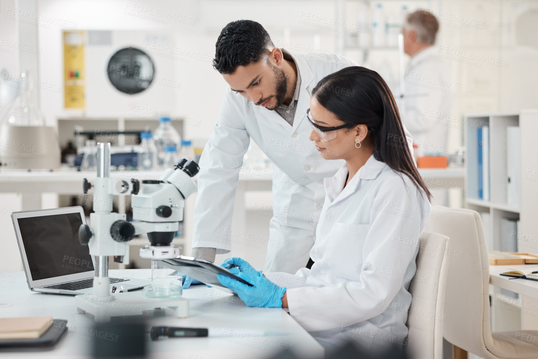 Buy stock photo Shot of two scientists working together in a lab