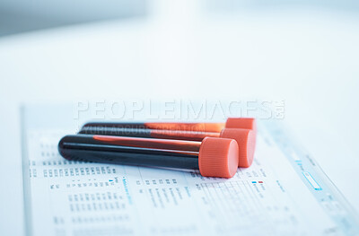 Buy stock photo Closeup shot of test tubes and paperwork on a table in a lab