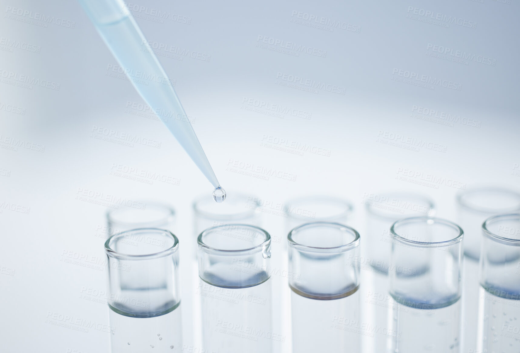 Buy stock photo Closeup shot of a dropper being used to fill test tubes in a lab