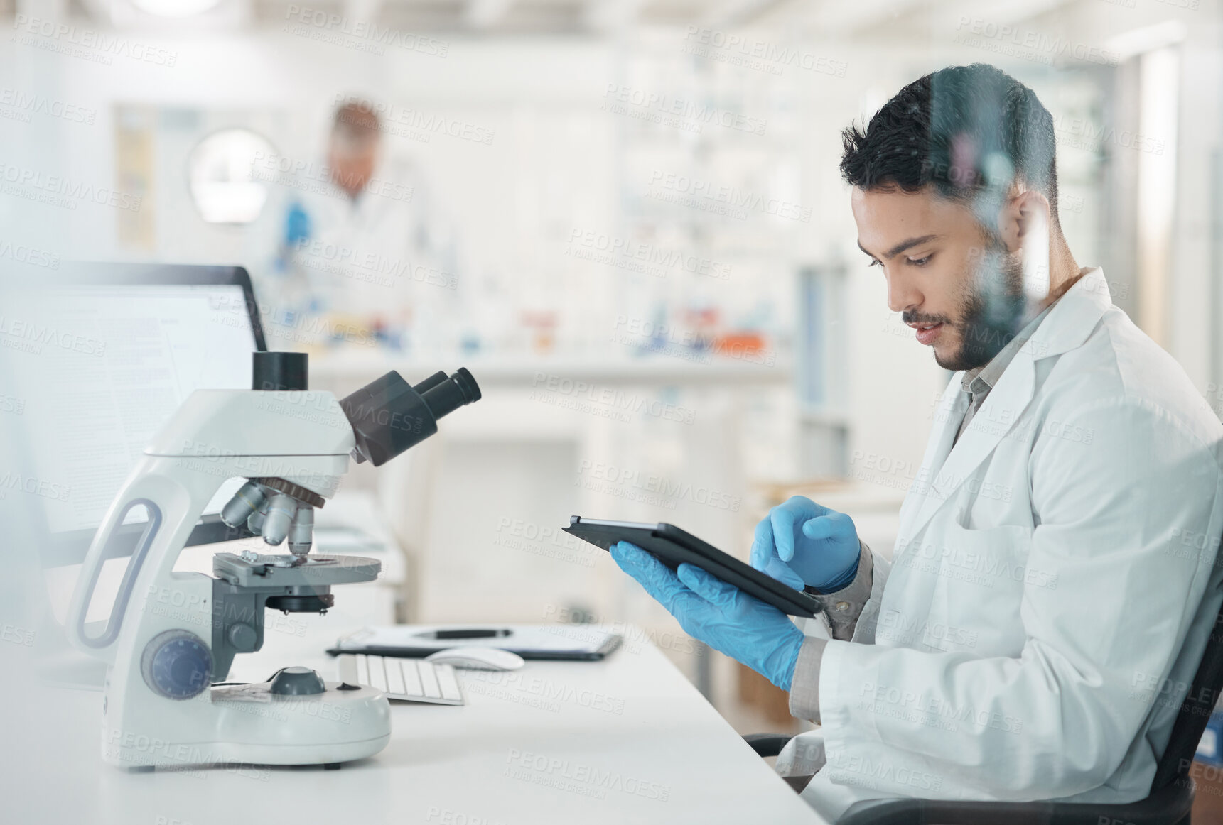 Buy stock photo Man, science lab and medical research with tablet, microscope and scientist in experiment. Male person, technology and pathology test for results, analysis or mpox vaccine in clinic or pharmaceutical