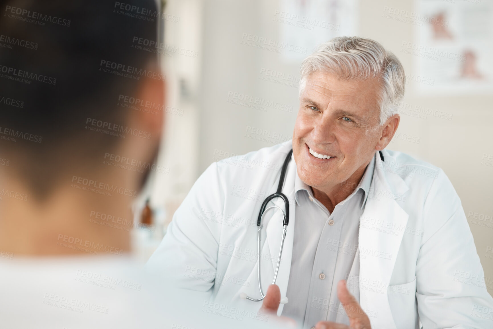 Buy stock photo Mature, happy man or doctor with patient for consultation, medical appointment or health advice at hospital. Senior, male person or cardiologist with smile or consulting client for healthcare service