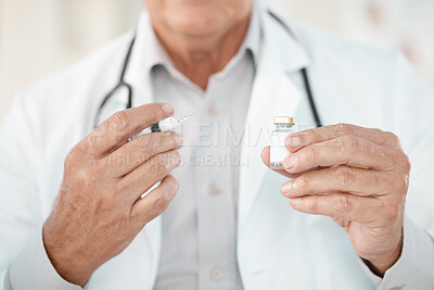 Buy stock photo Cropped shot of an unrecognisable doctor holding a syringe and vaccine in his clinic