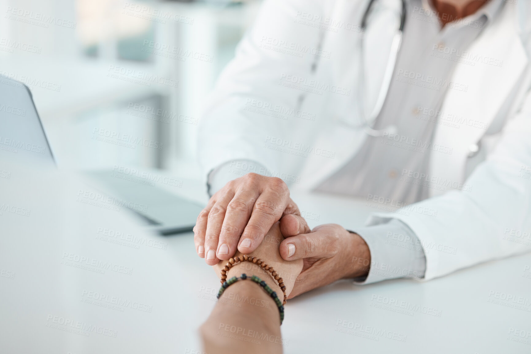 Buy stock photo Doctor, patient and holding hands with empathy for consultation, news or understanding at clinic. Closeup, medical employee or client for sympathy, counseling or support together on desk at hospital