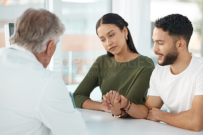 Buy stock photo Couple, holding hands and doctor for checkup in office of fertility treatment, ivf assessment and pregnancy news. Smile, people and gynecology support for family planning, progress and medical advice