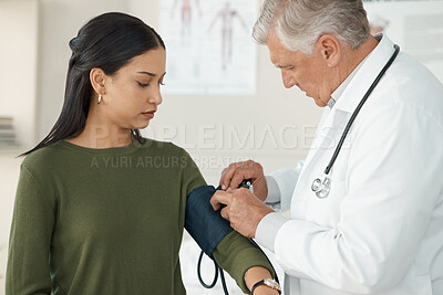 Buy stock photo Medical, blood pressure and mature doctor with a patient for a consultation in the hospital. Medicine, equipment and healthcare worker checking hypertension of a woman at a checkup in medicare clinic