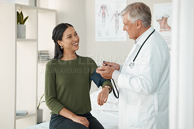 Buy stock photo Senior doctor, blood pressure and patient in a consultation, healthcare and appointment with treatment, diagnosis and results. Wellness check, woman or medical professional with cuff for hypertension