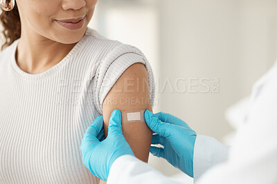 Buy stock photo Cropped shot of an unrecognisable doctor applying a band-aid after injecting her patient during a consultation in the clinic
