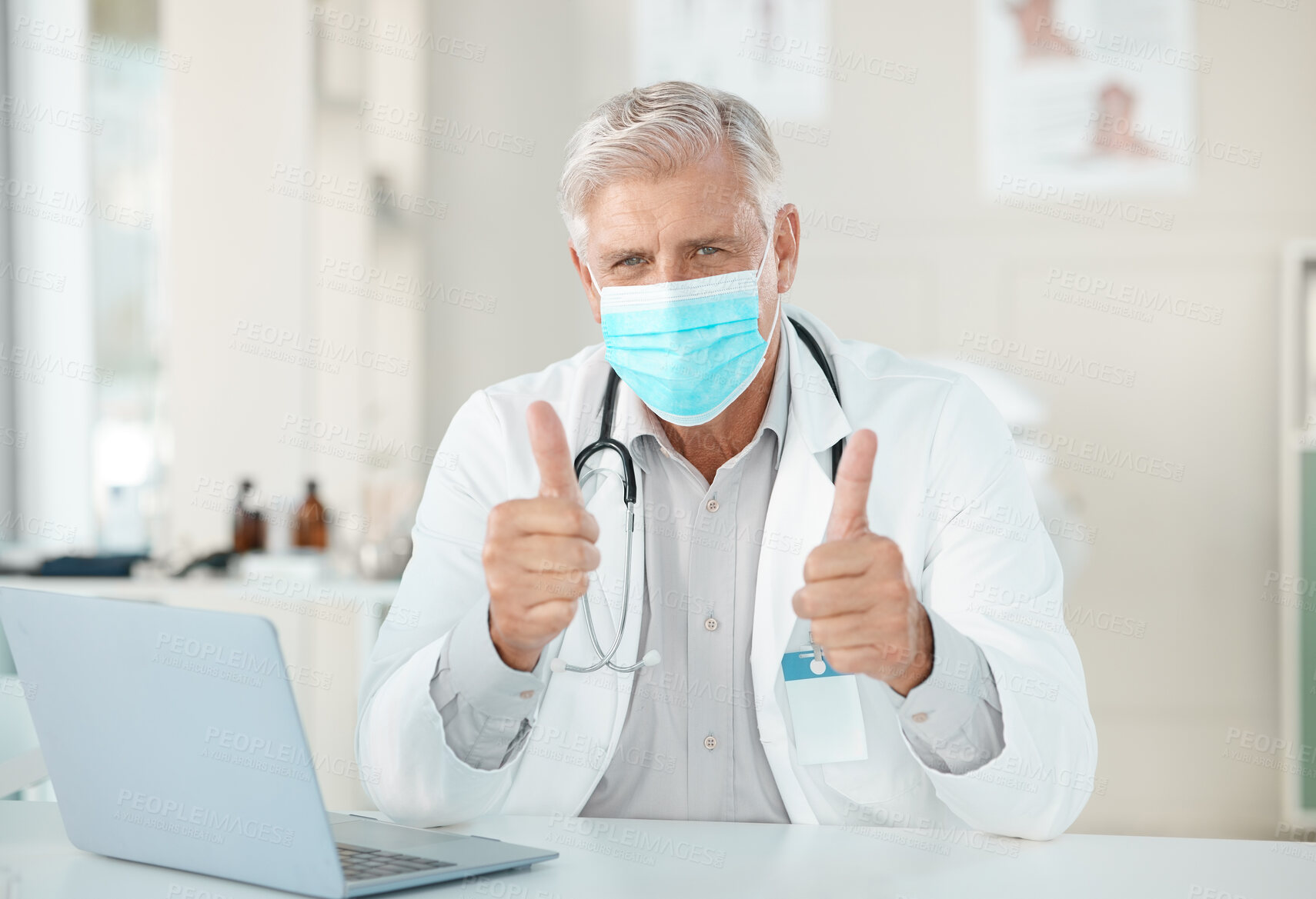 Buy stock photo Mature doctor, portrait and man with thumbs up or face mask for healthcare advice, safety or protection at hospital. Senior, male person or cardiologist with like emoji or yes sign for health service