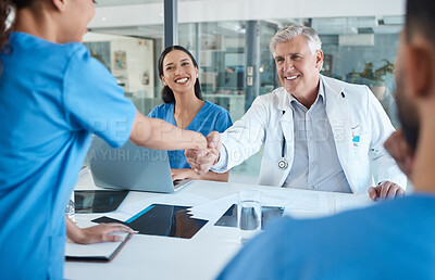 Buy stock photo Shot of a doctor shaking hands with a new hire
