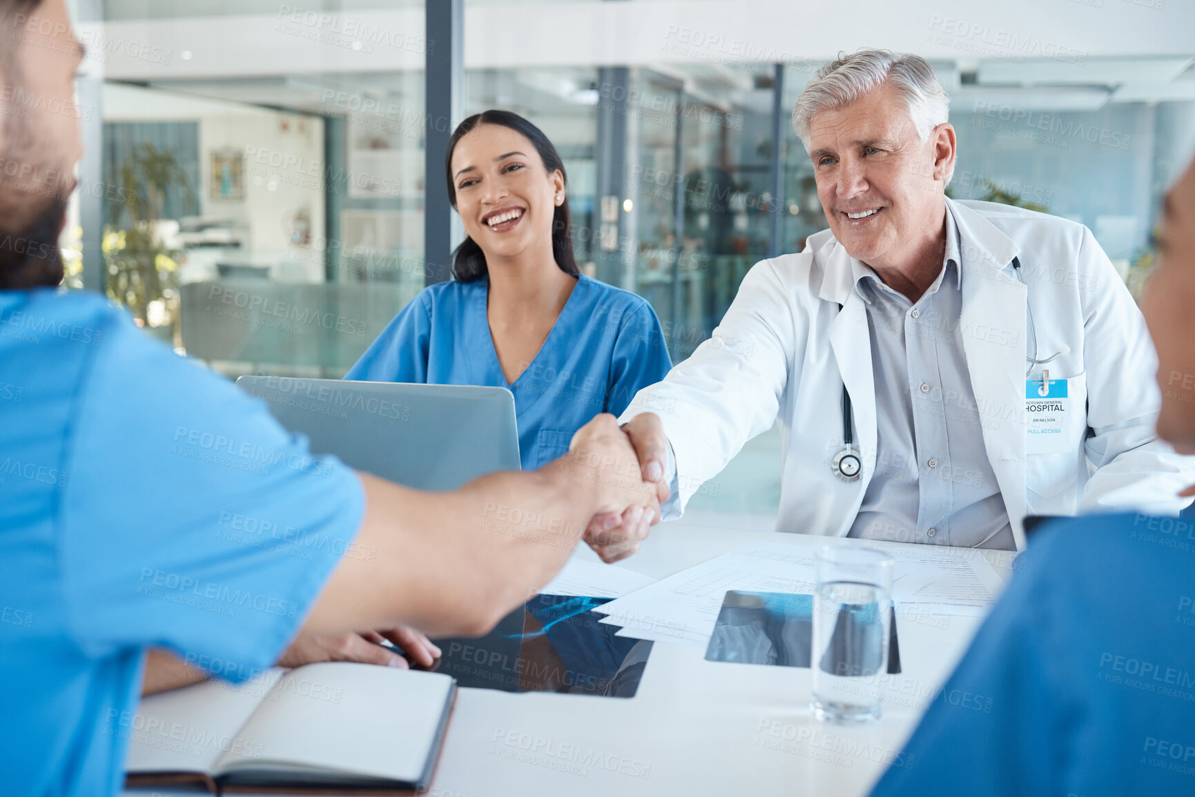 Buy stock photo Boardroom, medical team and happy with handshake on meeting for welcome, thank you and well done. Hospital, healthcare professional and people for collaboration, teamwork and coworking with documents