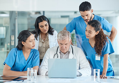 Buy stock photo Shot of a group of nurses having a meeting with their head doctor