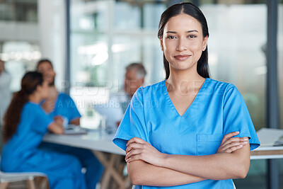 Buy stock photo Shot of a young nurse in the midst of a staff meeting