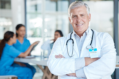 Buy stock photo Shot of a mature male doctor during a meeting