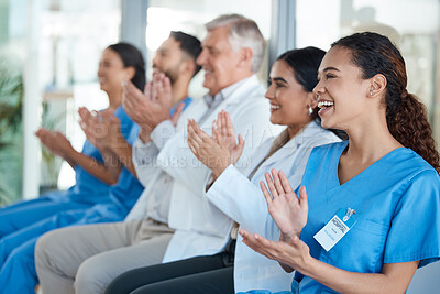 Buy stock photo Shot of a team of medical staff applauding during a conference