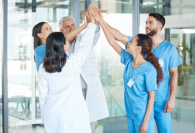 Buy stock photo Shot of a team of medical staff high fiving one another