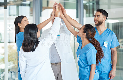 Buy stock photo Shot of a team of medical staff high fiving one another