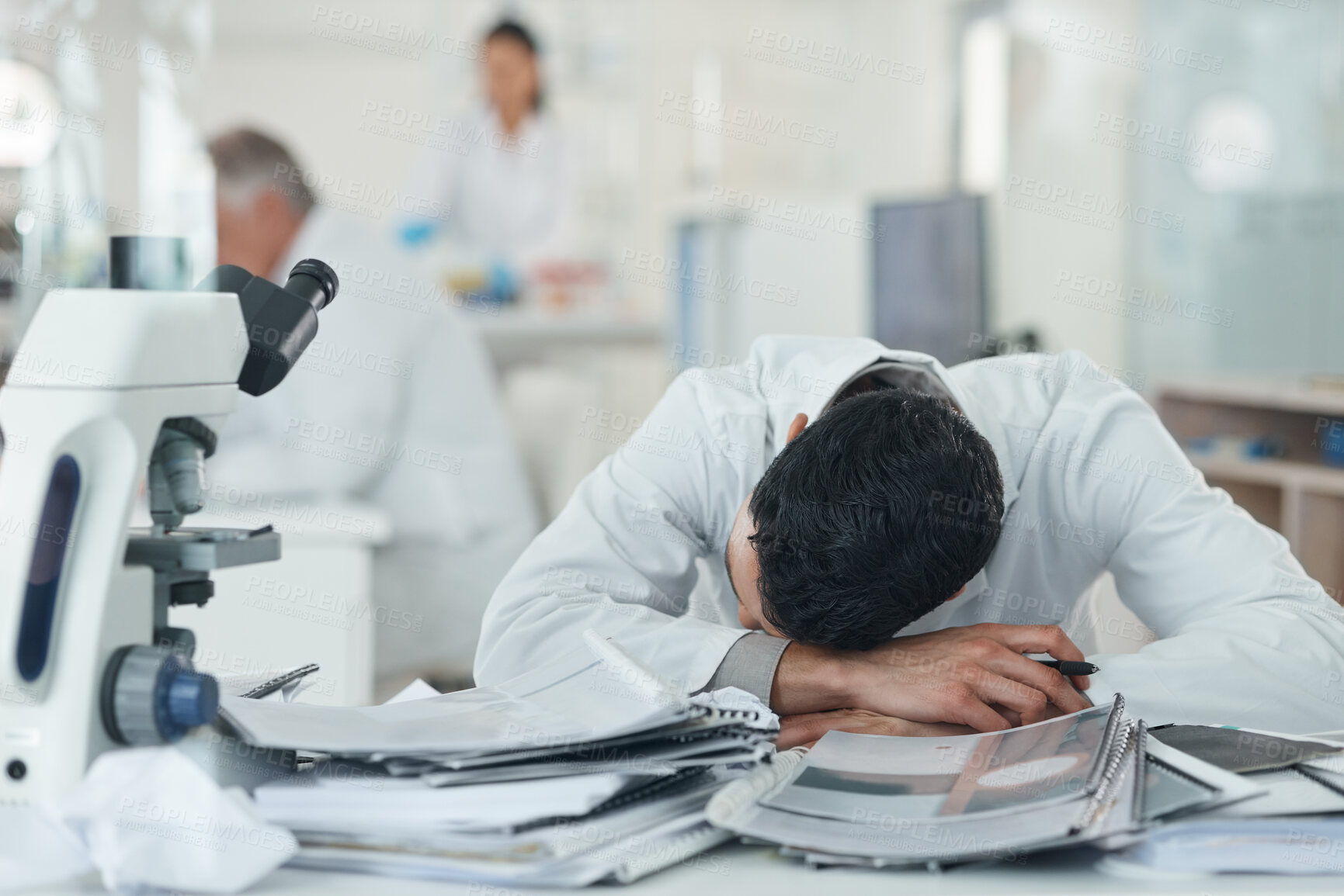 Buy stock photo Science, tired and man sleeping in laboratory with documents for medical analysis, research and study. Healthcare, biotechnology and scientist student with paperwork for burnout, fatigue and stress