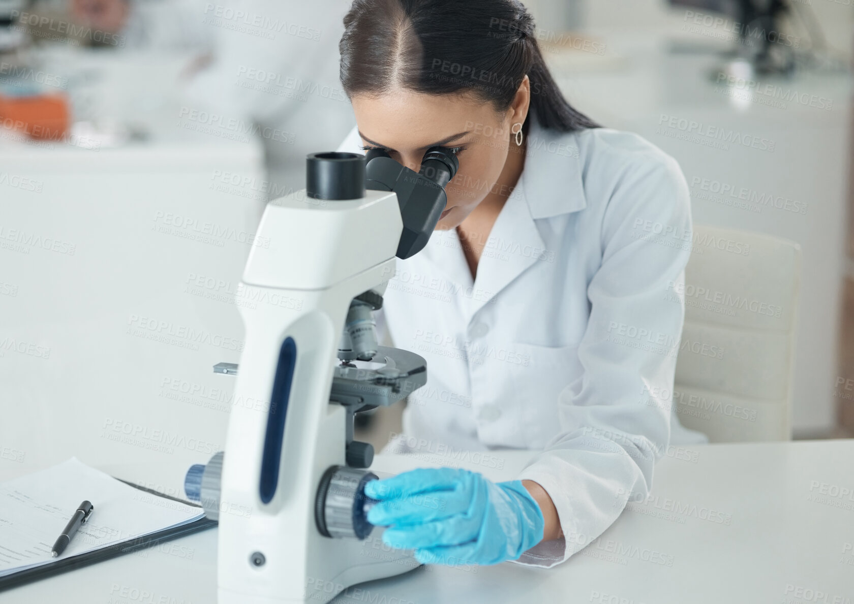 Buy stock photo Scientist, woman and microscope with biology research and medical analysis in clinic laboratory. Chemistry, testing and hospital tech for monkeypox vaccine and science with ppe gear for study