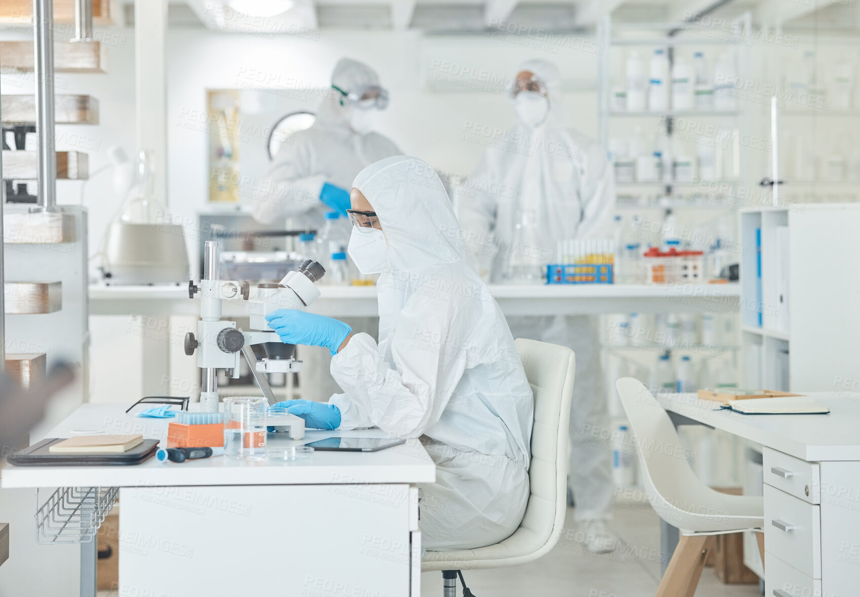 Buy stock photo Microscope, ppe and scientist checking virus, test results or pharmaceutical innovation with mask. Safety, person or lab technician at desk in bacteria research, medical danger or vaccine development