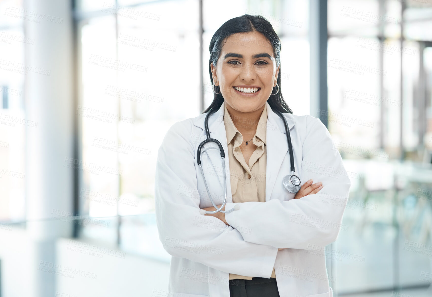 Buy stock photo Portrait, woman and healthcare with confident in hospital of medical service, diagnosis advice and career pride. Smile, surgeon and arms crossed for trust, about us and medicine treatment of wellness