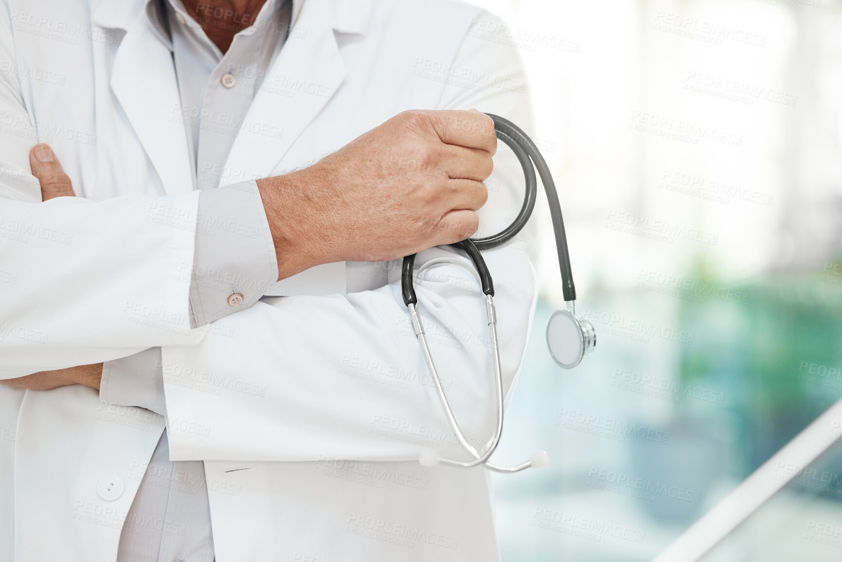 Buy stock photo Hands, man and doctor with arms crossed, stethoscope and confidence with equipment in clinic. Closeup, person and medical with professional, equipment and lab coat in hospital and career ambition