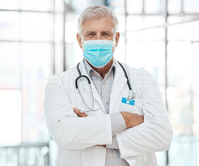 Buy stock photo Shot of a medical practitioner standing with his arms crossed in a hospital