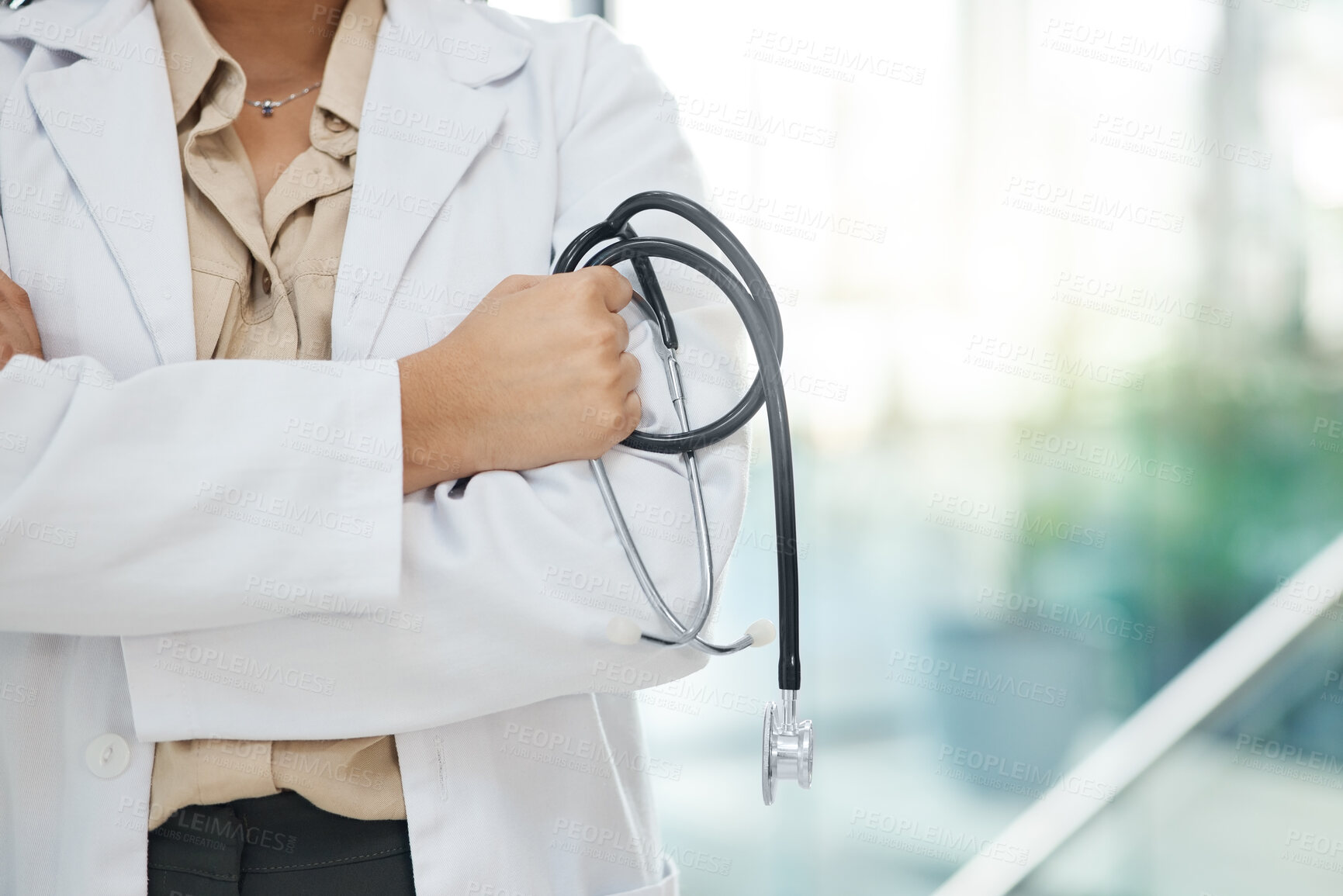 Buy stock photo Hands, woman and doctor with arms crossed, stethoscope and career ambition with equipment in clinic. Closeup, person and medical with professional, equipment and lab coat in hospital and wellness