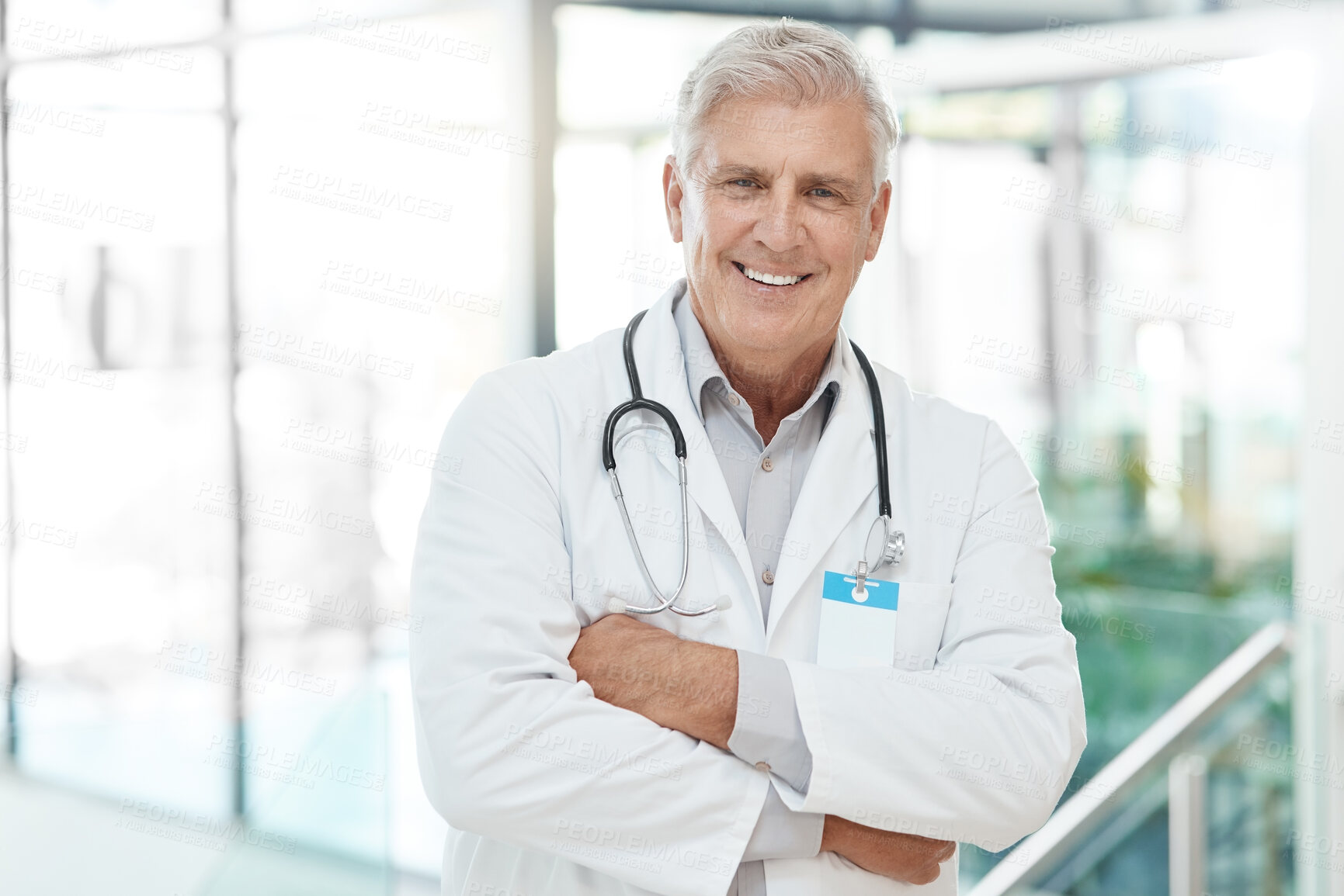 Buy stock photo Portrait, man and doctor with confident in hospital for medical service, diagnosis advice and career pride. Mature, surgeon and arms crossed with healthcare trust, about us and  treatment of wellness