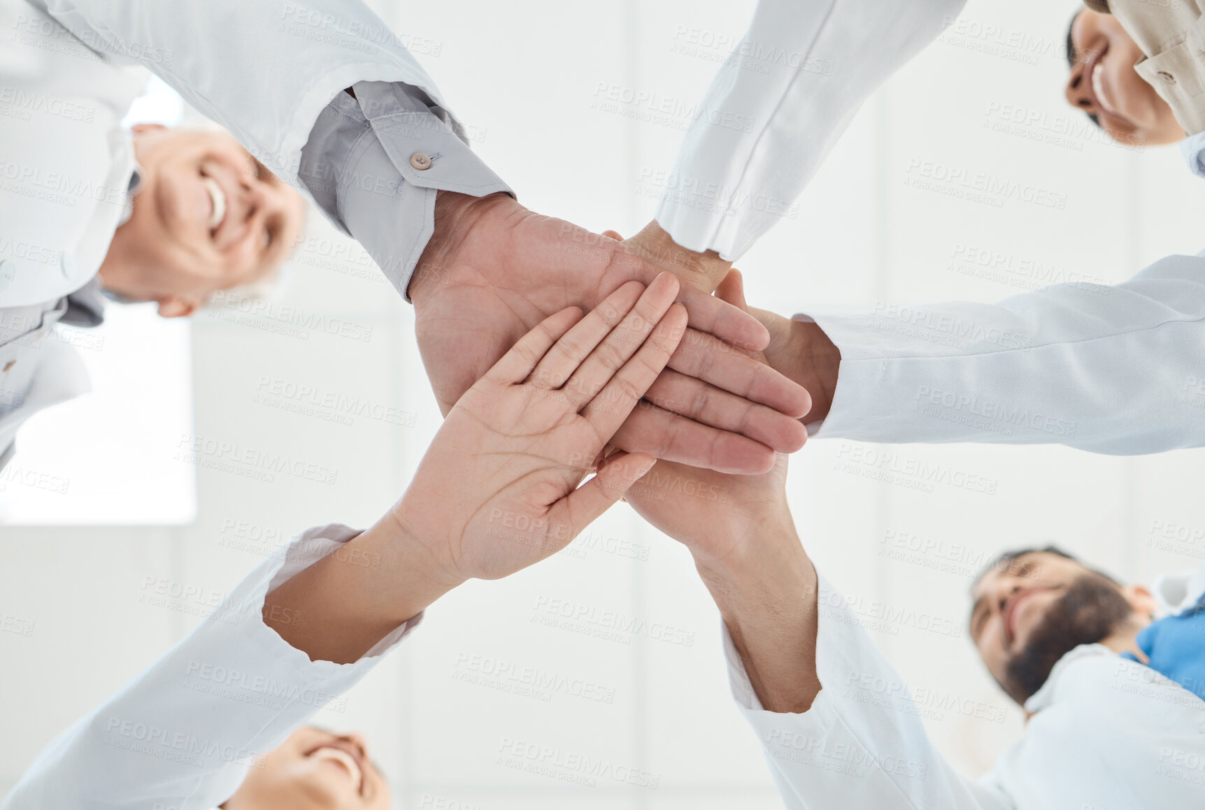 Buy stock photo Below, hand stack and people as doctors in hospital for teamwork, medical support and partnership circle. Staff, smile and diversity for team building, healthcare service and synergy of collaboration