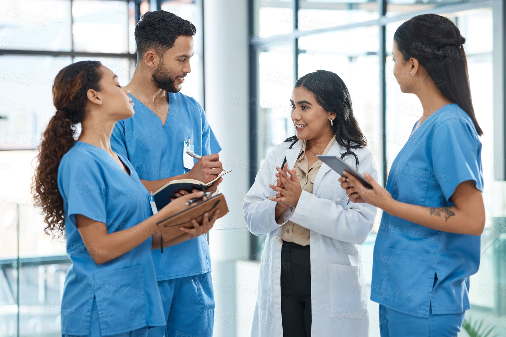Buy stock photo Shot of a group of medical practitioners having a discussion in a hospital