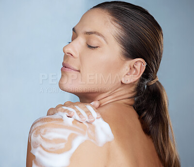 Buy stock photo Shot of a woman washing herself against a grey background