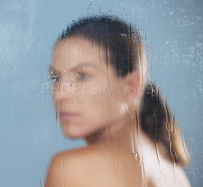 Buy stock photo Shot of a woman standing behind a steamy glass door