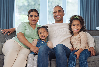 Buy stock photo Shot of two adorable little girls relaxing with their parents on the sofa at home